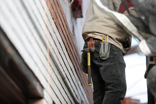 Person outside wearing a tool belt